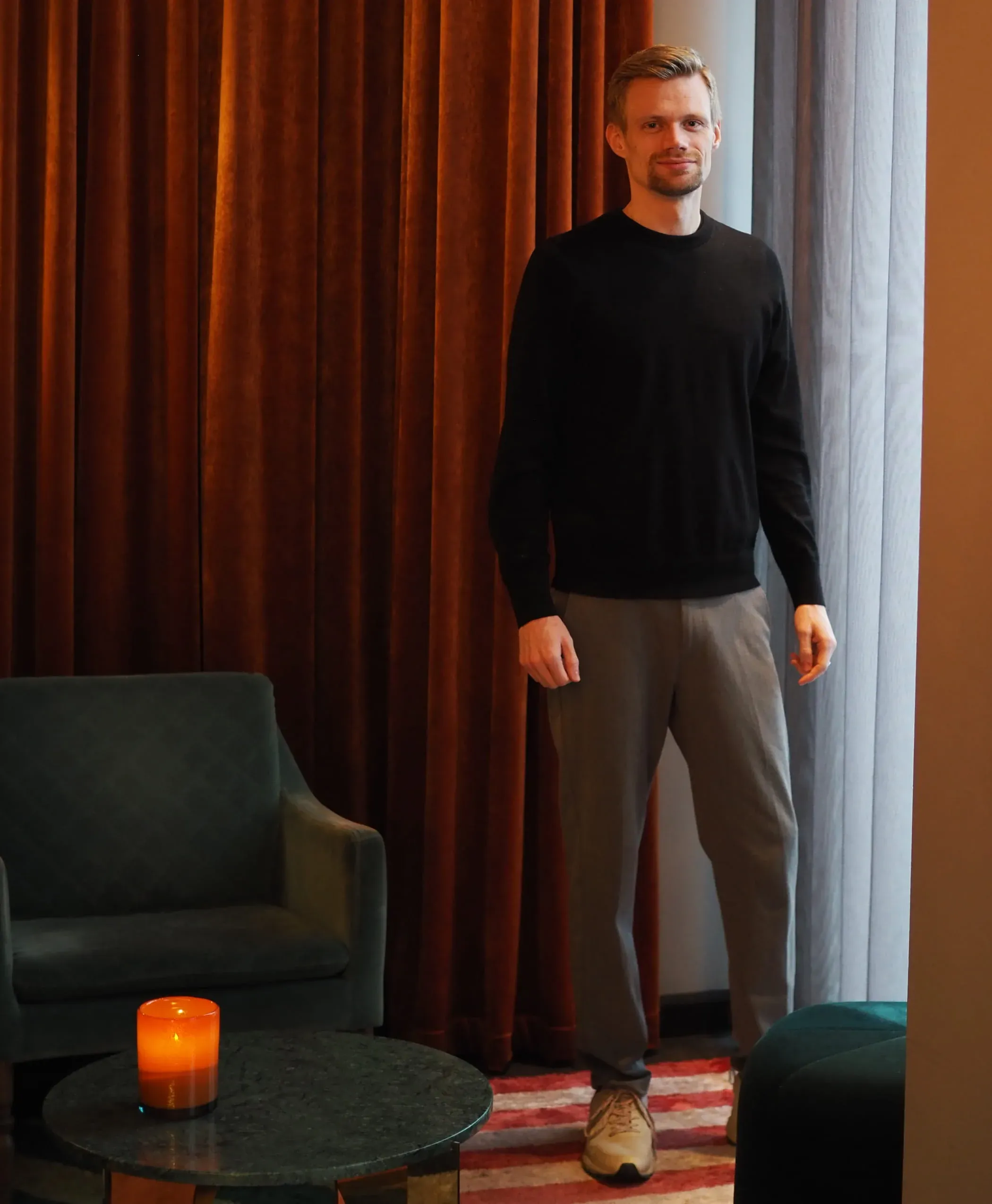 Mark Mogensen standing in a warmly lit room